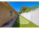 The side yard features a small putting green between the house and the fence at 2121 Park N St, St Petersburg, FL 33710