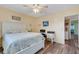 Comfortable bedroom with ceiling fan, desk area and wood flooring for a modern aesthetic at 2401 Ecuadorian Way # 57, Clearwater, FL 33763