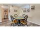 Charming dining area with a unique round table and beach-themed wall decor at 2401 Ecuadorian Way # 57, Clearwater, FL 33763