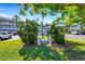 Beautifully landscaped entrance to condo complex with decorative statues and mature trees at 2401 Ecuadorian Way # 57, Clearwater, FL 33763