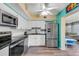 Bright kitchen with stainless steel appliances and white cabinets at 2401 Ecuadorian Way # 57, Clearwater, FL 33763