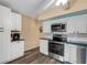 Bright kitchen with stainless steel appliances and white cabinets at 2401 Ecuadorian Way # 57, Clearwater, FL 33763