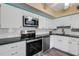 Modern kitchen features stainless steel appliances and white cabinets at 2401 Ecuadorian Way # 57, Clearwater, FL 33763