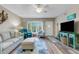 Comfortable living room featuring laminate floors, ceiling fan, and modern decor at 2401 Ecuadorian Way # 57, Clearwater, FL 33763