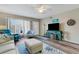 Open-concept living room with ceiling fan, laminate floors, and serene color palette at 2401 Ecuadorian Way # 57, Clearwater, FL 33763