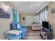 Living room with a comfortable blue armchair, sofa, and bright natural light at 2401 Ecuadorian Way # 57, Clearwater, FL 33763