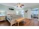 Main bedroom with updated floors, bench, and ensuite bath and living room access at 2401 Ecuadorian Way # 57, Clearwater, FL 33763