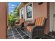 Inviting covered front porch with tiled flooring and comfortable seating with beautiful light fixtures at 2495 13Th N Ave, St Petersburg, FL 33713