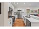 Kitchen featuring modern appliances, white cabinets, marble countertops, and a tile backsplash at 2495 13Th N Ave, St Petersburg, FL 33713