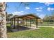 Outdoor picnic area featuring covered shelter, tables, and a serene lakeside view at 2495 13Th N Ave, St Petersburg, FL 33713