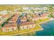 An aerial view of the bayfront neighborhood featuring lush landscaping, tile roofs, and bay access at 250 Seagate Ct, Dunedin, FL 34698
