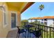Inviting outdoor seating area on balcony overlooking lush landscaping and ocean views at 250 Seagate Ct, Dunedin, FL 34698