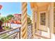 Balcony view with decorative columns, wrought iron railings, overlooking the street and nearby buildings at 250 Seagate Ct, Dunedin, FL 34698