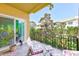 Outdoor balcony featuring patio furniture and a scenic view of lush trees and neighborhood buildings at 250 Seagate Ct, Dunedin, FL 34698