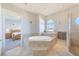 Bright bathroom featuring soaking tub, walk in shower and tile flooring at 250 Seagate Ct, Dunedin, FL 34698