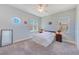 Neutral bedroom featuring carpet, ceiling fan, round window, and natural light at 250 Seagate Ct, Dunedin, FL 34698
