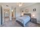Bedroom featuring carpet flooring, a bed, and an adjacent hallway with bathroom at 250 Seagate Ct, Dunedin, FL 34698