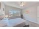 Bedroom featuring carpet flooring, a bed, and a chair near the window at 250 Seagate Ct, Dunedin, FL 34698