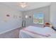 Bright bedroom with a window, ceiling fan, and carpet floors at 250 Seagate Ct, Dunedin, FL 34698