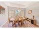 Open dining room with tray ceilings, tile floors, and large windows at 250 Seagate Ct, Dunedin, FL 34698