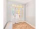 Front entrance showcasing tiled floors and a white door with glass panels at 250 Seagate Ct, Dunedin, FL 34698
