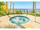Hot tub overlooking the bay and beachfront area surrounded by tropical landscaping at 250 Seagate Ct, Dunedin, FL 34698