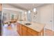 Charming kitchen island with granite countertop adjacent to an elegant dining room with tile floors at 250 Seagate Ct, Dunedin, FL 34698