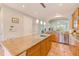 Bright kitchen featuring granite counters, wood cabinets, stainless appliances, and tiled floors at 250 Seagate Ct, Dunedin, FL 34698