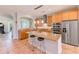 Spacious kitchen with stainless steel appliances, granite counters, and a large island with seating at 250 Seagate Ct, Dunedin, FL 34698