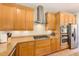 Bright kitchen with wooden cabinets, granite countertops, stainless steel appliances, and modern fixtures at 250 Seagate Ct, Dunedin, FL 34698
