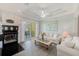 Cozy living room with fireplace, sliding doors to a balcony, and comfortable seating at 250 Seagate Ct, Dunedin, FL 34698