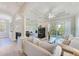 Bright and airy living room with fireplace, balcony access, and stylish decor at 250 Seagate Ct, Dunedin, FL 34698