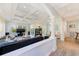 Spacious living room with coffered ceiling, modern fireplace, and wood-look floors at 250 Seagate Ct, Dunedin, FL 34698