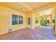 Covered patio area featuring tiled flooring, natural light, and an inviting atmosphere for outdoor living at 250 Seagate Ct, Dunedin, FL 34698