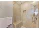 Shower stall with a bench, clear glass enclosure, and tiled walls at 250 Seagate Ct, Dunedin, FL 34698