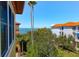 Balcony view overlooking community, palm trees, and the ocean at 250 Seagate Ct, Dunedin, FL 34698