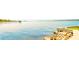 Picturesque water view with a stone seawall, offering a peaceful and scenic outdoor experience at 250 Seagate Ct, Dunedin, FL 34698