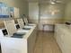 Bright community laundry room with multiple washers and dryers for tenant convenience at 2699 Seville Blvd # 808, Clearwater, FL 33764