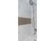 Shower with gray and white marble tiles, a gray mosaic accent stripe, and a chrome shower head at 2699 Seville Blvd # 808, Clearwater, FL 33764