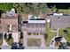 This aerial view showcases a home with a pool, canal access, and a spacious driveway with mature landscaping at 3105 S Canal Dr, Palm Harbor, FL 34684