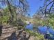 Picturesque backyard canal with a dock, surrounded by lush greenery, offering a serene and private retreat at 3105 S Canal Dr, Palm Harbor, FL 34684