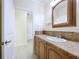 A bathroom with a cabinet and view into another room at 3105 S Canal Dr, Palm Harbor, FL 34684