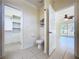 Open view of the toilet, and sink with access to the living room and closet, enhancing accessibility at 3105 S Canal Dr, Palm Harbor, FL 34684