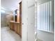 Bathroom showcases a shower, a cabinet for storage, and a bright window for ventilation and light at 3105 S Canal Dr, Palm Harbor, FL 34684