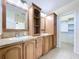 Bathroom featuring double sinks, cabinets, and a separate room for closet enhancing the functionality and comfort at 3105 S Canal Dr, Palm Harbor, FL 34684