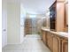Bathroom featuring a glass shower, double vanity, and plenty of storage cabinets for toiletries and essentials at 3105 S Canal Dr, Palm Harbor, FL 34684