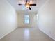 An empty bedroom with neutral colors and ceramic tile floors at 3105 S Canal Dr, Palm Harbor, FL 34684
