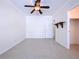An empty bedroom with neutral colors, ceramic tile floors, and a ceiling fan at 3105 S Canal Dr, Palm Harbor, FL 34684
