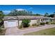 Charming single-Gathering home with a brick driveway, a one car garage, and inviting front porch at 3105 S Canal Dr, Palm Harbor, FL 34684
