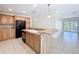Spacious kitchen with tile flooring, peninsula, and view to the outside patio at 3105 S Canal Dr, Palm Harbor, FL 34684